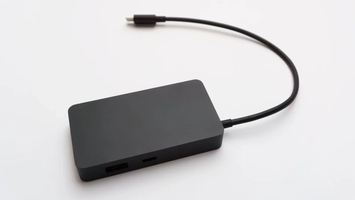 A sleek portable external hard drive with a connected cable, ideal for data storage.