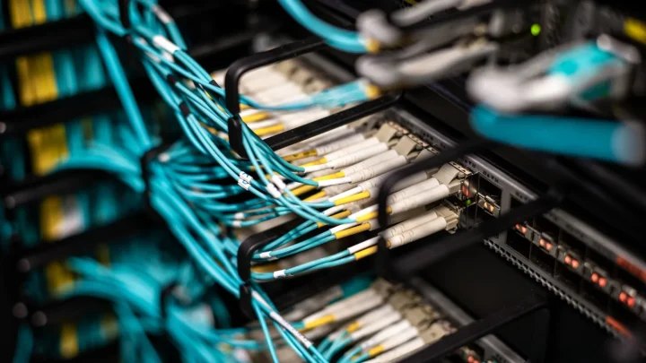 Numerous wires and cables mounted into server patch panel in modern data center