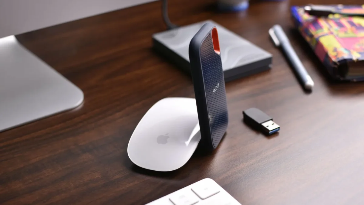 Stylish workspace setup showcasing modern technology gadgets on a wooden desk.