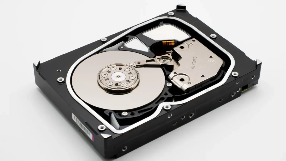 Detailed view of an open internal hard disk drive showing platters and read/write arm.