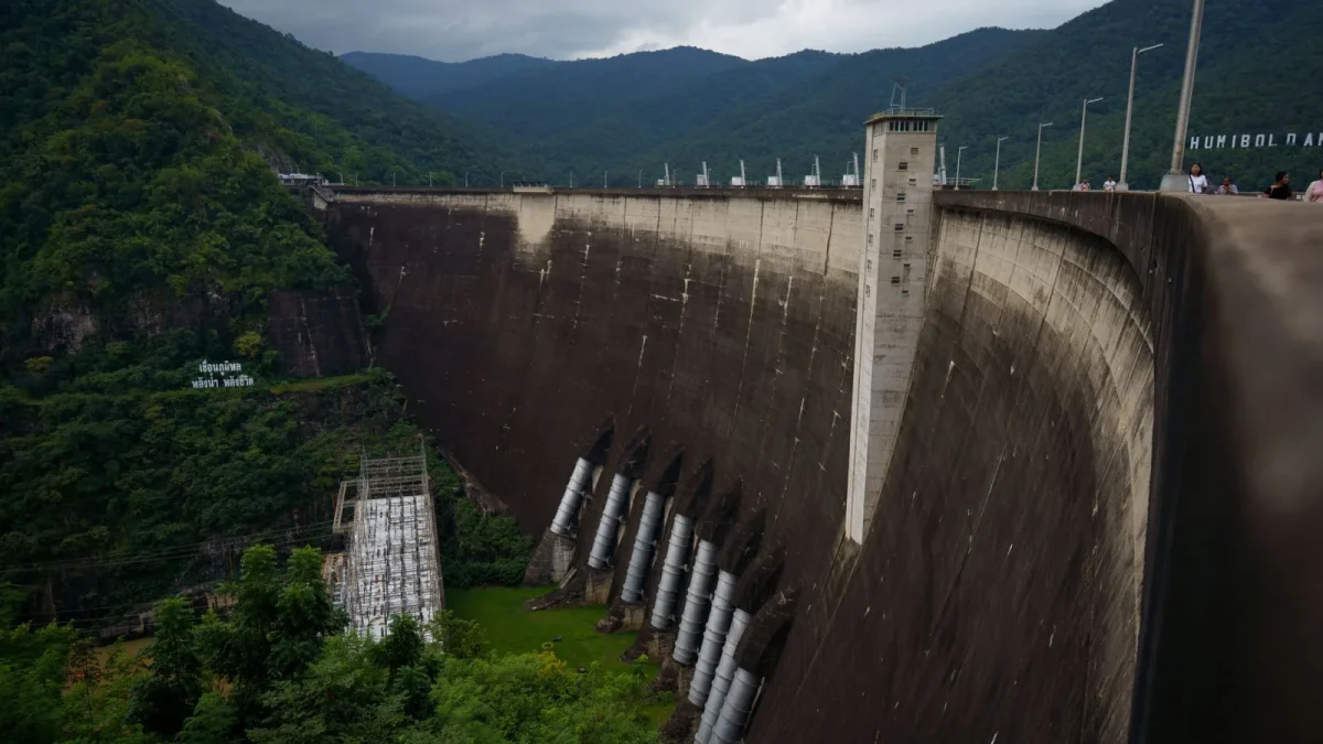 Bhumibol Dam in Ban Na, Tak, Thailand, surrounded by lush greenery and mountains.