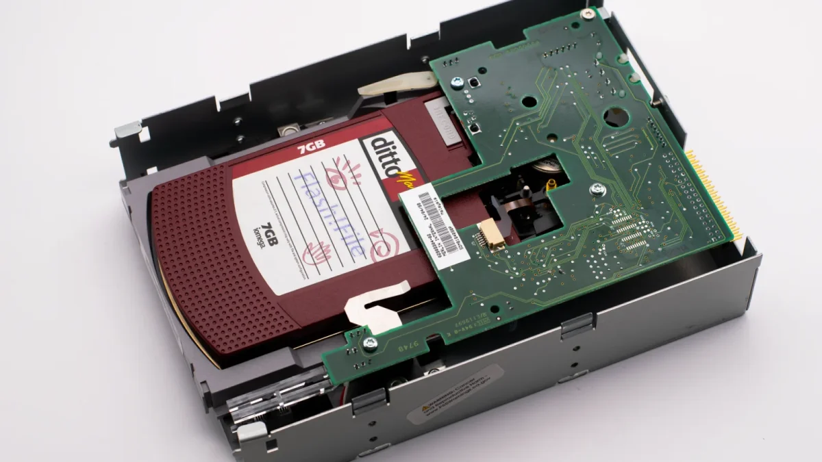 Detailed view of an internal computer disk drive showing circuit boards and components.