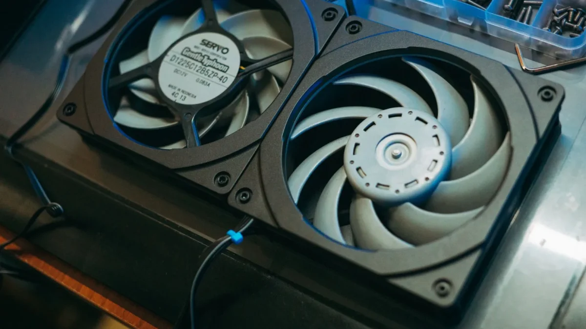 Pair of computer cooling fans on a metal surface for heat dissipation.