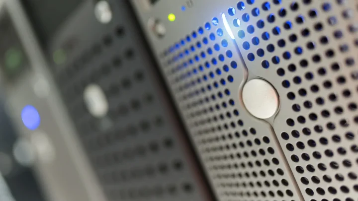 Focused detail of a modern server rack with blue LED indicators in a data center.
