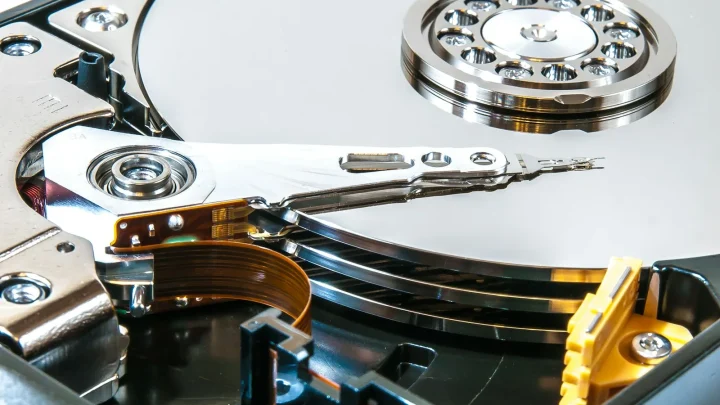 a close up of a hard drive with a pair of scissors