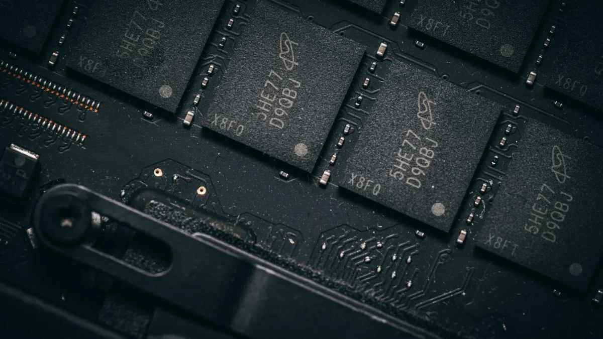 Detailed shot of microchips on a circuit board, showcasing electronic technology and precision engineering.