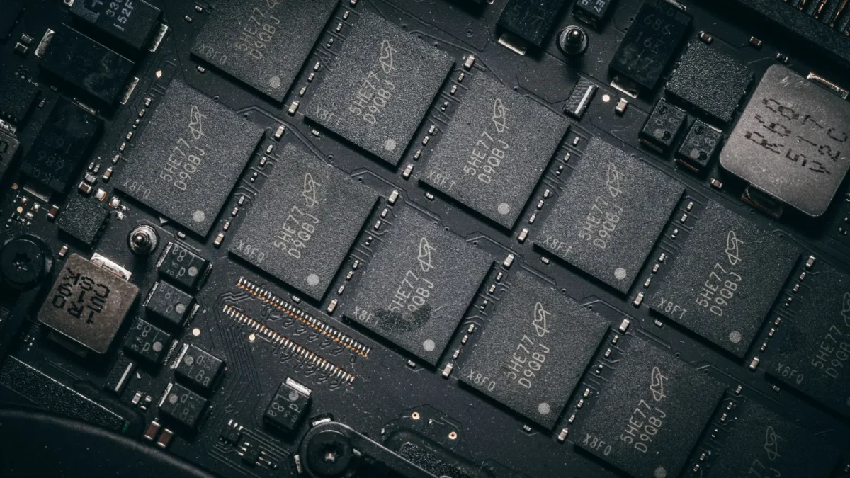 Detailed view of electronic circuit board components showcasing microchips and technology intricacies.