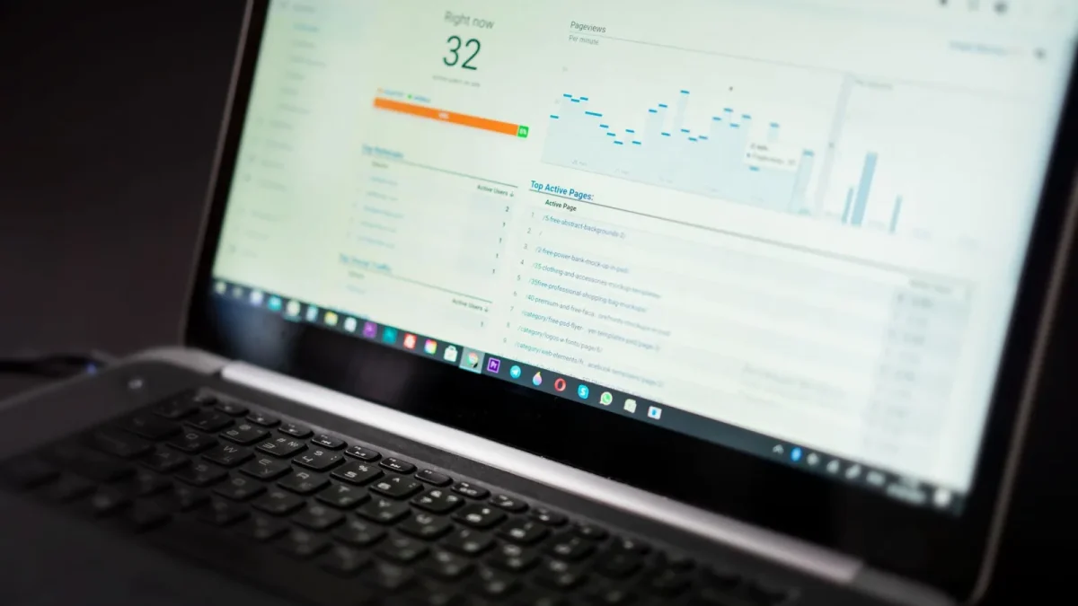 A laptop displaying an analytics dashboard with real-time data tracking and analysis tools.
