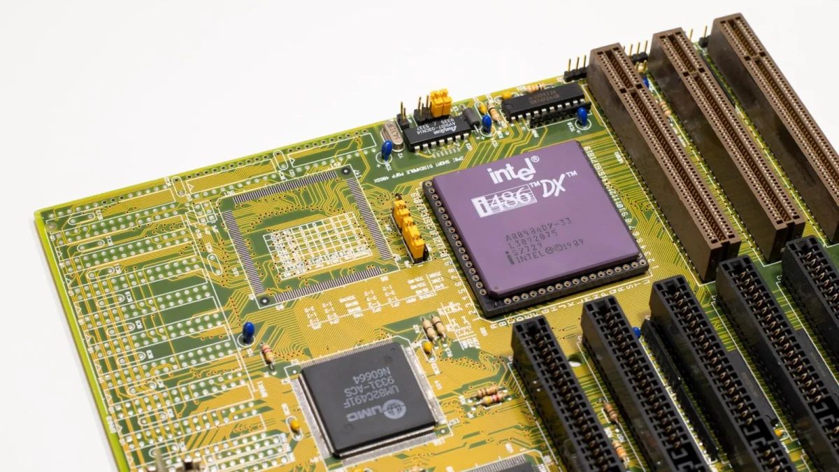 Close-up of a vintage Intel 486 CPU motherboard with PCI slots, highlighting retro technology components.