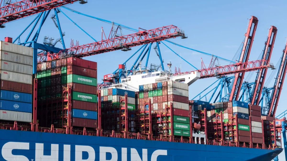 Shipping containers and cranes at Hamburg port showcasing global trade.