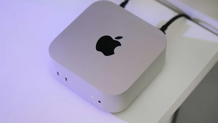 An apple computer sitting on top of a white table