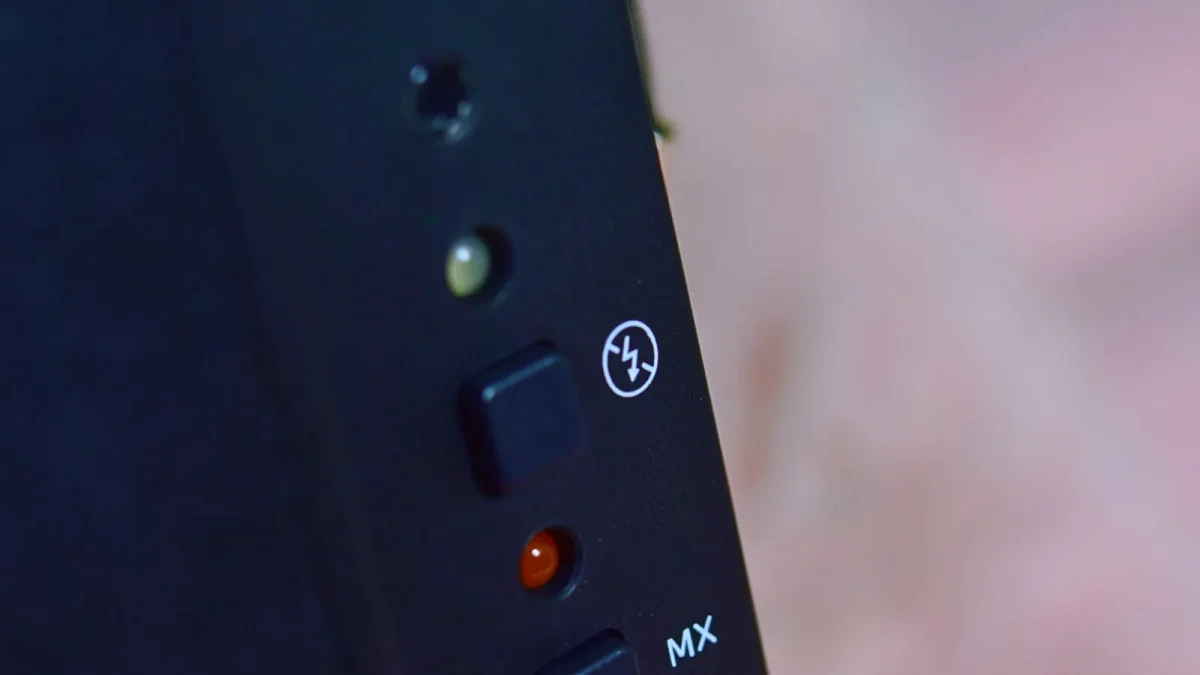 Detailed close-up of buttons on a black electronic device with control indicators.