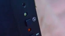 Detailed close-up of buttons on a black electronic device with control indicators.