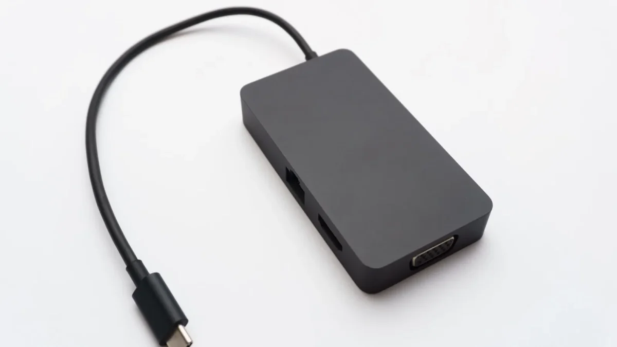 Sleek USB-C hub with HDMI, USB, and Ethernet ports on white background.
