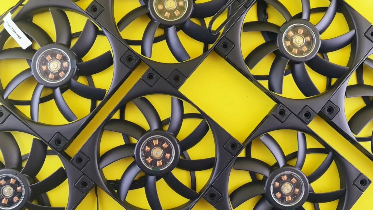 Multiple black CPU cooling fans arranged on a vibrant yellow background, showcasing tech elements.