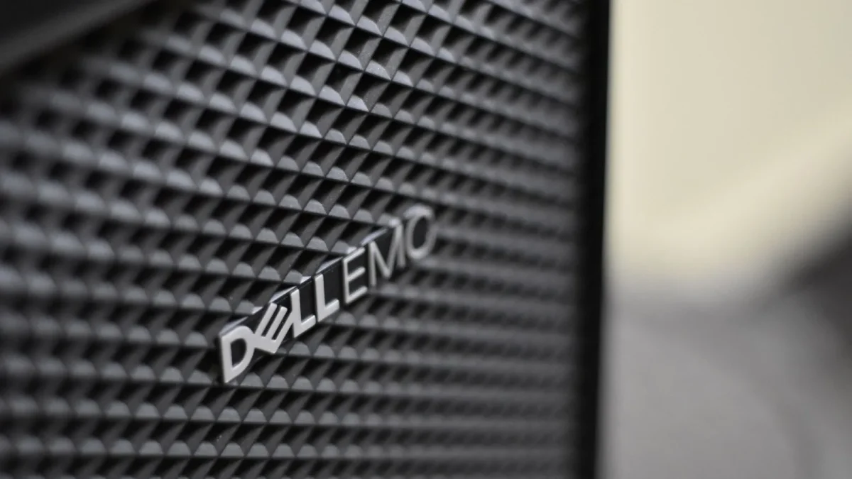 Detailed close-up of Dell EMC server logo on hardware grill with shallow focus and textured patterns.