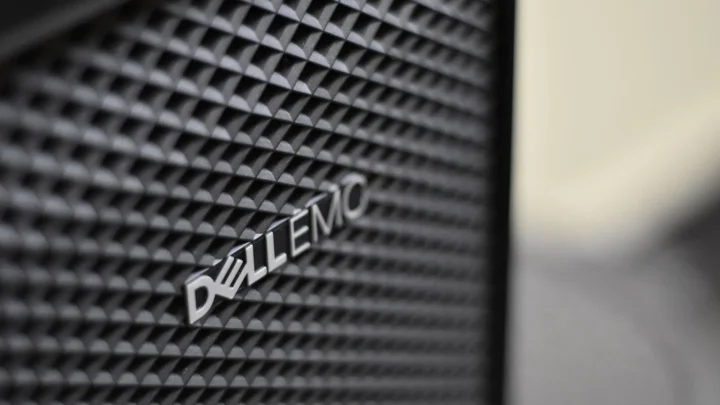 Detailed close-up of Dell EMC server logo on hardware grill with shallow focus and textured patterns.