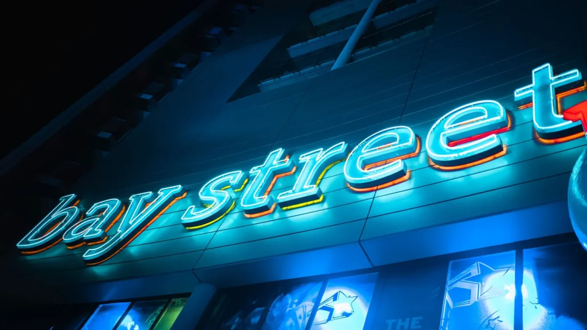 Colorful neon sign of Bay Street in San Ġiljan, Malta, glowing at night.