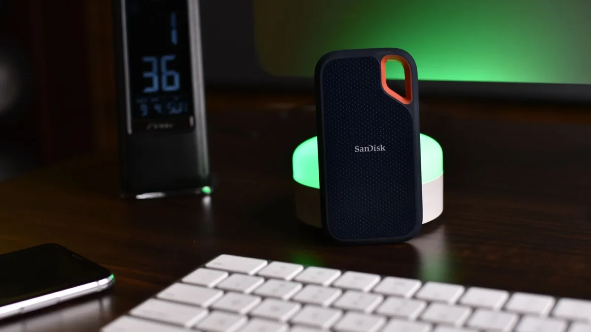 Stylish desk setup featuring a SanDisk external drive, keyboard, and ambient lighting.
