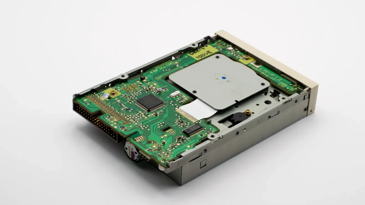 Close-up view of a vintage hard drive's internal circuit board with visible components and connectors.