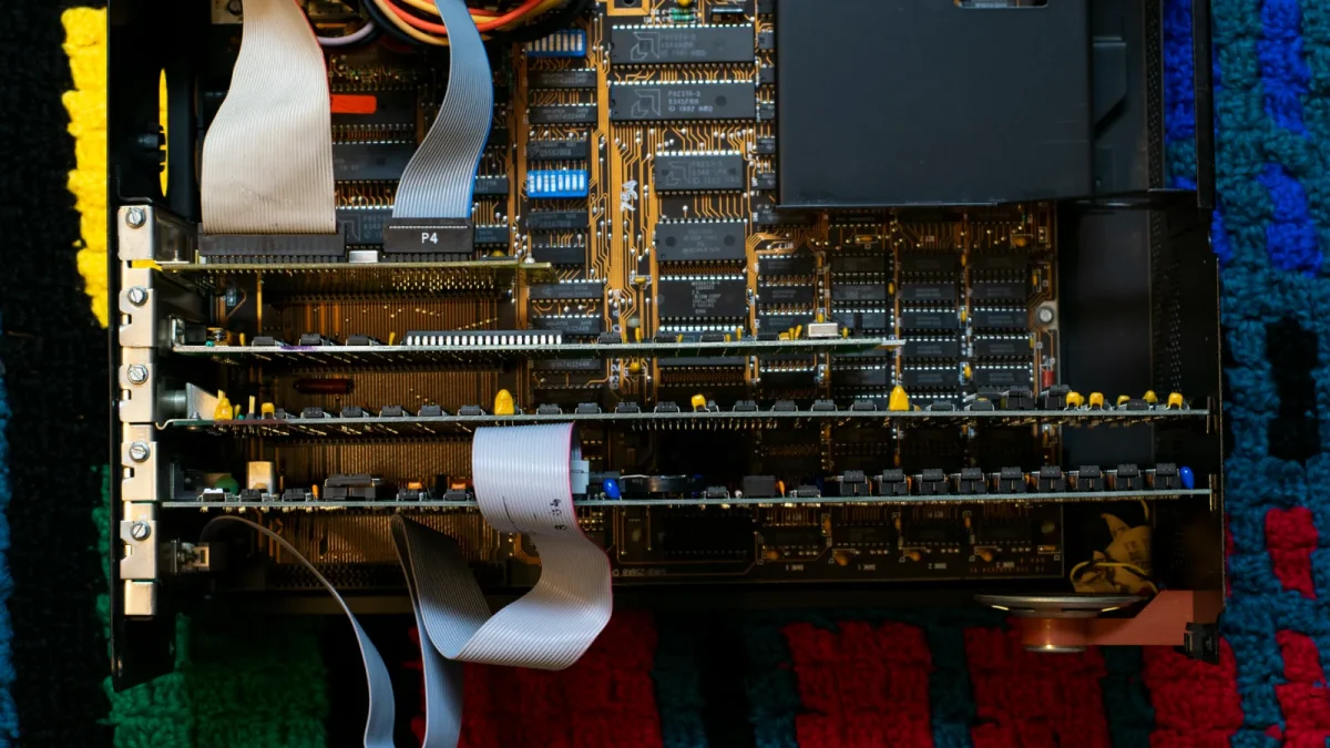A vintage circuit board showcasing intricate electronic components and ribbon cables.