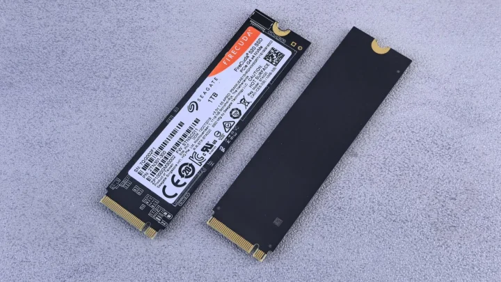Two NVMe SSDs, Seagate FireCuda, on a gray background for tech enthusiasts.