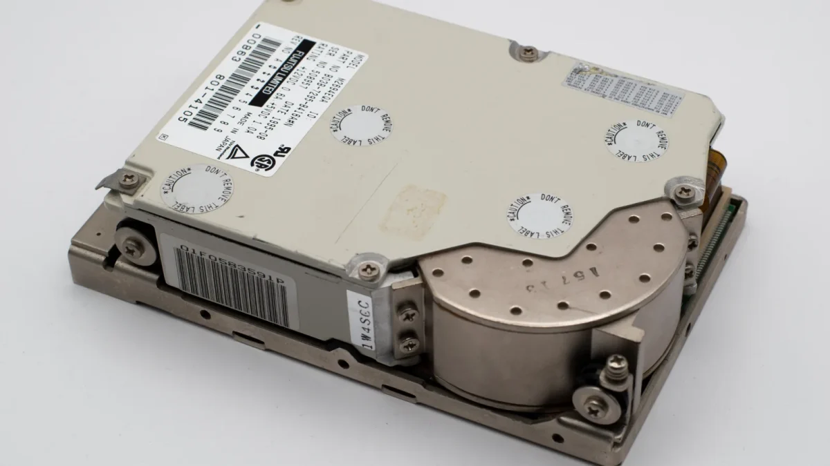 Close-up of a vintage hard drive, showcasing its metal casing and intricate design.