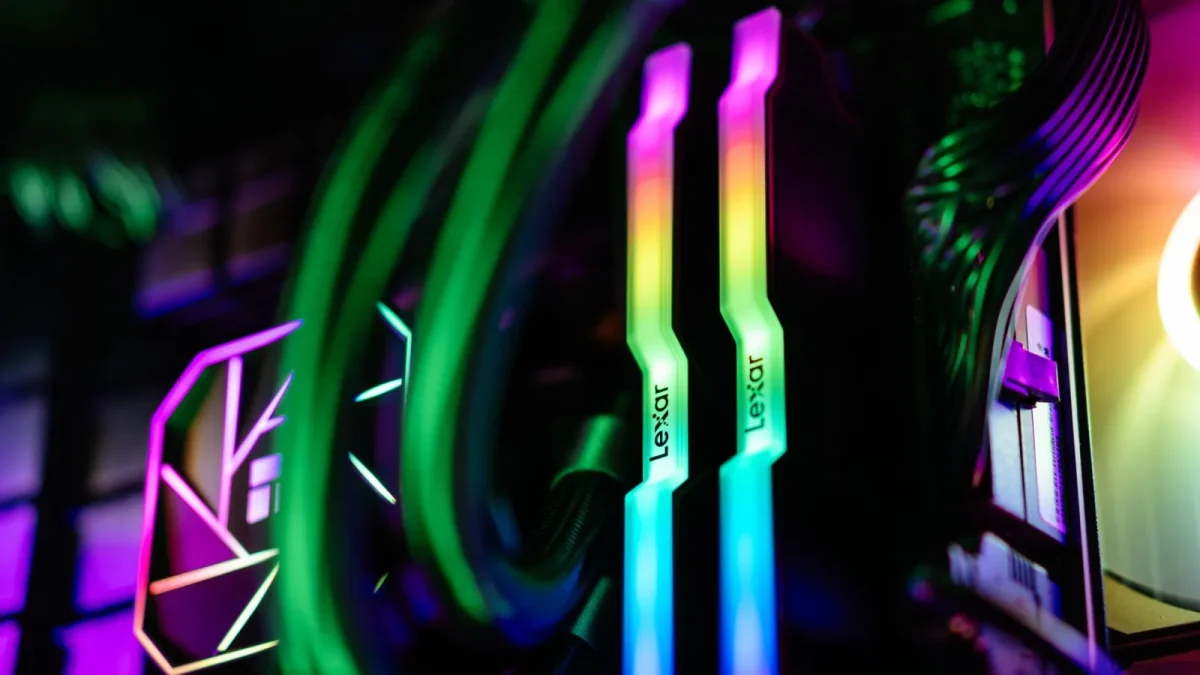 Close-up of colorful RGB illuminated PC components showcasing RAM and cooling system.