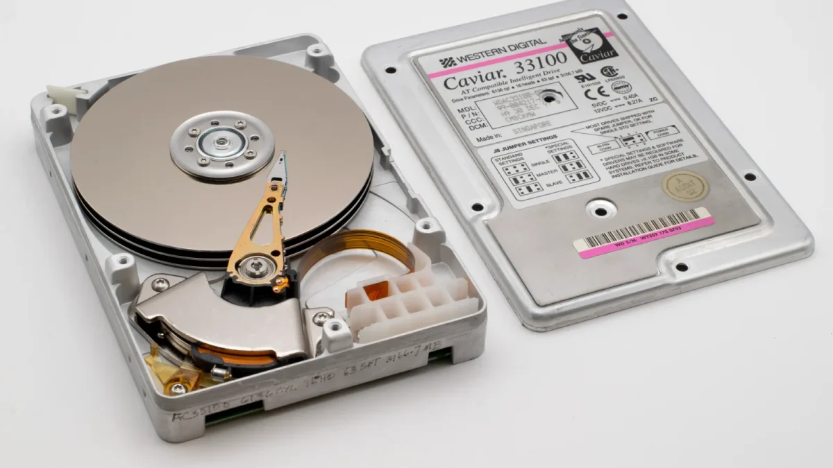 Old Western Digital hard drive open, showing platters and circuit board.