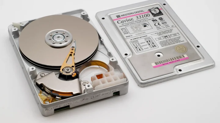 Old Western Digital hard drive open, showing platters and circuit board.