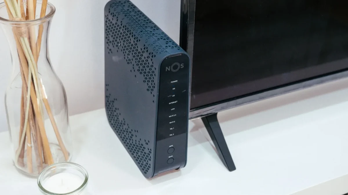A sleek home technology setup featuring a router, glass decoration, and television.