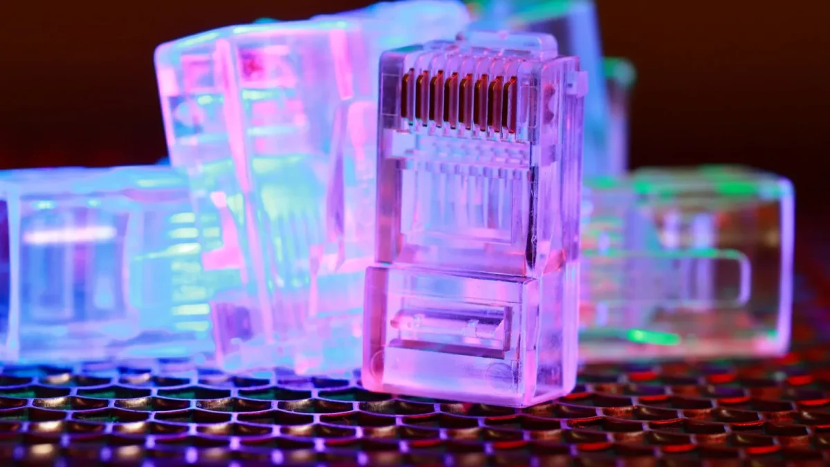 Vibrant close-up of network cable connectors with colorful lighting.