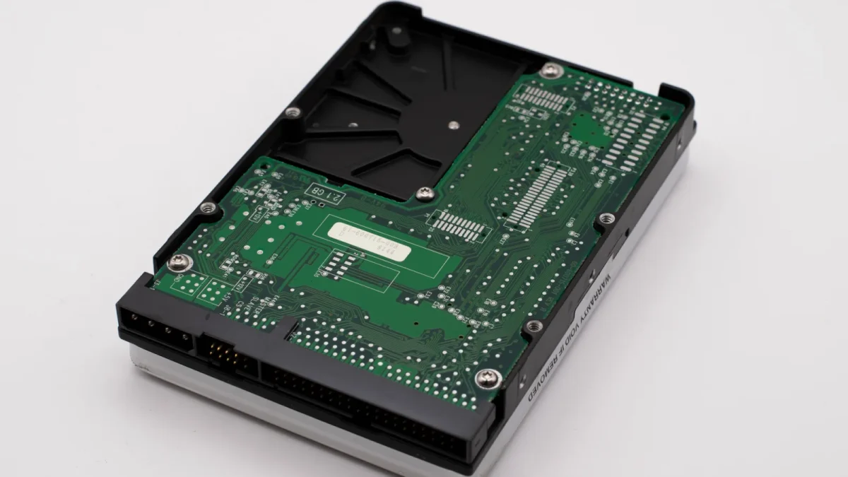Detailed view of a hard disk's printed circuit board showcasing electronics and data storage components.
