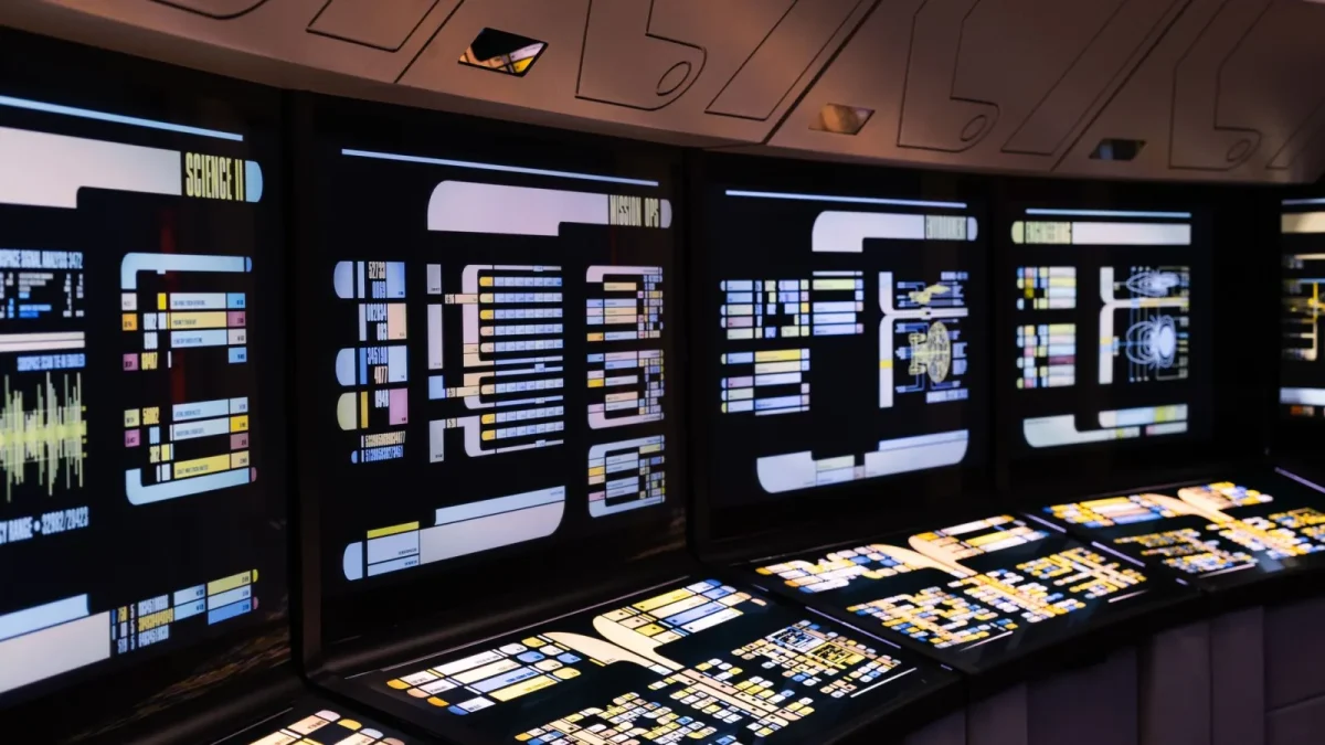 A high-tech command center with illuminated digital screens in a futuristic setting.